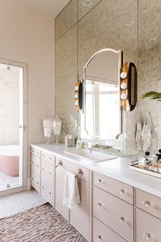 a bathroom with two sinks, mirrors and a bathtub in the middle of it