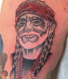 an old man with long braids and a hat on his head is shown in this tattoo