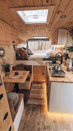 the interior of a tiny home with wood paneling and white walls, including a bed