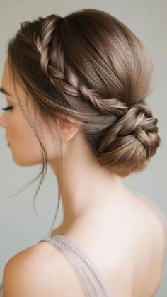 a woman with long hair in a braid updo