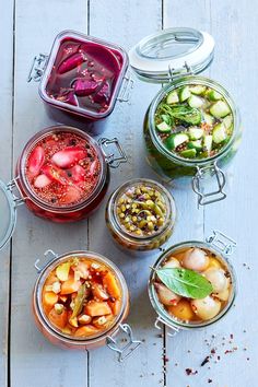 four jars filled with different types of food