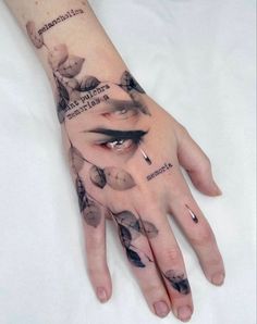 a woman's hand with tattoos on it