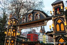 the entrance to an outdoor christmas market in germany