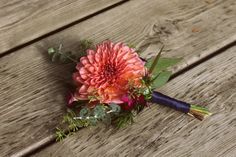 a bouquet of flowers sitting on top of a wooden bench