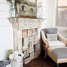 a living room filled with furniture and a fire place covered in books on top of a hard wood floor