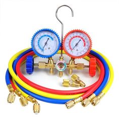 three different gauges and hoses connected to each other