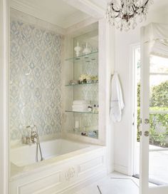 an instagram page for interior design and decorating company in the usa, featuring a white bathroom with blue damask wallpaper