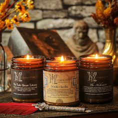 three candles sitting on top of a wooden table