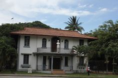 a large white house sitting on the side of a road