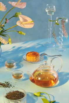 tea and flowers on a blue table cloth