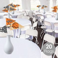 there are many tables and chairs that have decorations on them in the shape of basketballs