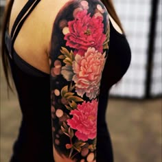 a woman with a flower tattoo on her arm