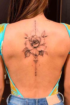 a woman with a rose tattoo on her back