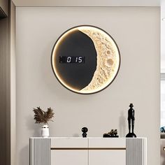 a clock that is on the side of a wall next to a cabinet and table