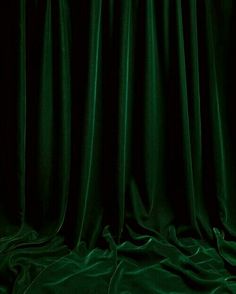 a dark green curtain is draped over the floor