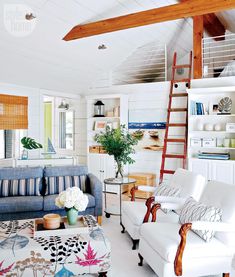 a living room filled with furniture and a ladder