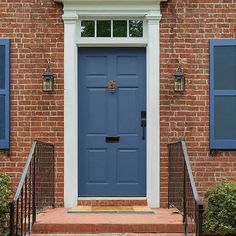 a blue front door on a brick house