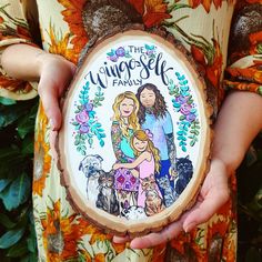 a woman holding a wood slice with an image of her family on it