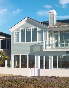 an artist's rendering of a house on the beach with large windows and balconies