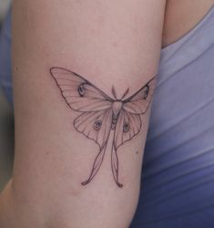 a woman with a butterfly tattoo on her arm