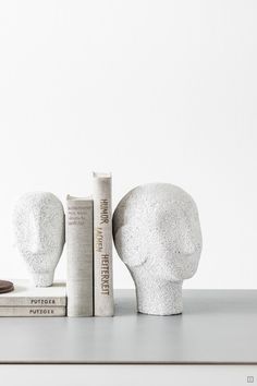 two bookends made out of concrete sitting next to each other on a table