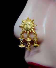 the sun and moon earrings are attached to a mannequin's earring