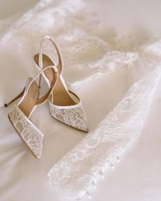 wedding shoes and lace on a white bed sheet