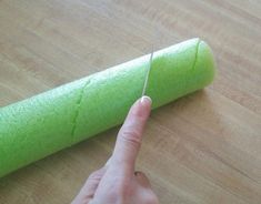 a person is using a pair of scissors to cut the end of a piece of felt