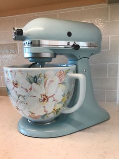 a blue mixer sitting on top of a counter