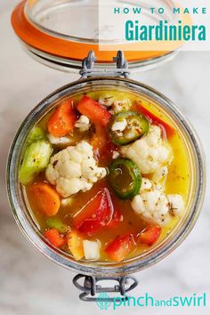 a glass jar filled with vegetables next to a sign that says delicious giardira