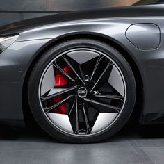 the front wheel of a grey sports car