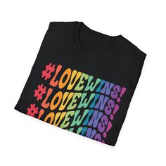 a black t - shirt with the words love wins and rainbows on it's chest