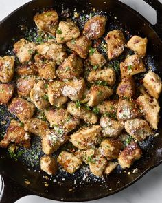 chicken in a skillet with parsley on top