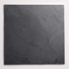 a black slate tile on a white wall