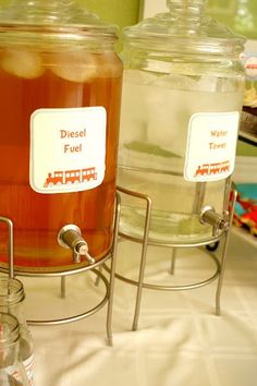 three jars filled with liquid sitting on top of a table