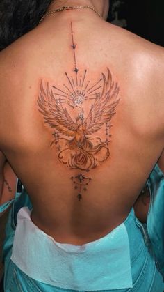 the back of a woman's neck with an angel tattoo on her left side