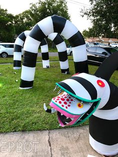 an inflatable black and white dog with sunglasses on it's head is sitting outside