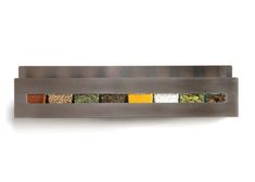 the spice rack is made from stainless steel and has five different kinds of spices in it