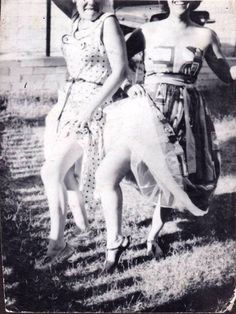 an old black and white photo shows three women in dresses standing next to each other