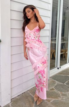 Pink Floral Ruffle Maxi Dress

How to style:
This beautiful maxi dress () is the epitome of all girly and frilly dresses. This dress is a must have for all our pink lovers. Pair this gorgeous dress with white or nude accessories () to make this adorable dress stand out on its own.

Features:
  
 * Maxi length 
 * Light weight satin material 
 * Slight stretch 
 * Fully lined 
 * Ruffle detailing 
 * Invisible left side zip 
 * V neckline 
 * Thin straps 
 * Criss cross back adjustable tie Graduation Party Dresses Guest, Floral Dresses Aesthetic, Backyard Wedding Guest Outfit, Quince Guest Outfit Dresses, Long Birthday Dress, Pink Dress Wedding Guest, Pink Long Dresses, Floral Pastel Dress, Garden Party Outfits