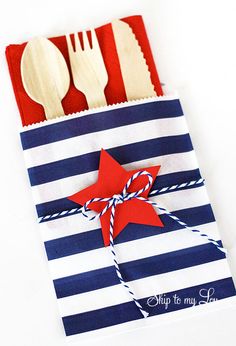 a red white and blue striped bag with spoons, fork and knife on it