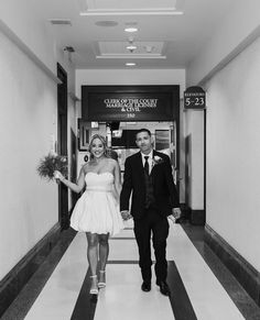 a man and woman walking down a hallway