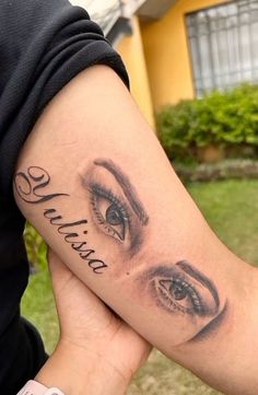 a woman's arm with an eye tattoo on it