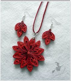 a red necklace and earring set made out of paper