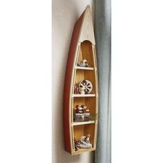 a canoe shaped shelf is mounted on the wall