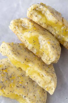 three pieces of food that have been placed on wax paper with sprinkles