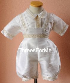 Classic christening outfit, our rompers are great for hot weather. Elegant 7 piece christening outfit soft Poly-Shantung silk , inside fully lined for fresh comfort. Includes short sleeve shirt with back button closure. Romper shorts are ankle length, wide style fit with elastic waistband for better fit. Easy button opening on romper from inside legs. Removable shoulder stole with hand decorated image of a cross outlined with pearls. Matching hat and fabric shoes are also included along with mat Elegant First Communion Dress For Summer Confirmation, Elegant Baptism Dress With Short Sleeves, Elegant First Communion Dress For Summer, Classic Cream Baptism Dress, Elegant Short Sleeve First Communion Summer Dress, Elegant Short Sleeve Formal Baptism Dress, Elegant Short Sleeve Baptism Dress For Summer, Elegant Cream Baptism Dress For Summer, Formal Short Sleeve Baptism Dress For Summer