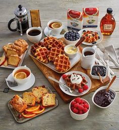 a table topped with waffles, fruit and coffee