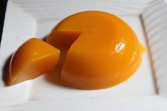 an orange that has been cut in half on a white plate with other food items