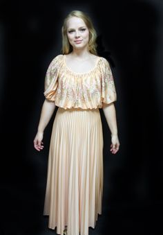 "70s J C Penney Fashion Gown, Empire Waist Long Dress,  polyester long dress, maxi dress, granny gown, peasant dress, long pleated skirt Pretty in pastel peach, this empire waisted print top/ solid bottom gown is made by J C Penney Fashion. Size 8, the washing instructions say Dry Clean Only, but I guess perhaps this was early in the days of polyester - or so this fabric feels to me like poly. I could be wrong.  The attached flowing lightly pleated skirt has a few stains (no effort has been made Vintage Fitted Maxi Skirt For Party, Fitted Vintage Maxi Skirt For Party, Spring Party Vintage Maxi Dress, Billowy Floor-length Maxi Dress For Spring, Spring Flowy Maxi Dress With Full Skirt, Spring Evening Maxi Dress With Full Skirt, Vintage Maxi Spring Dresses, Retro Long Spring Dress, Vintage Dresses With Ruffles And Long Skirt